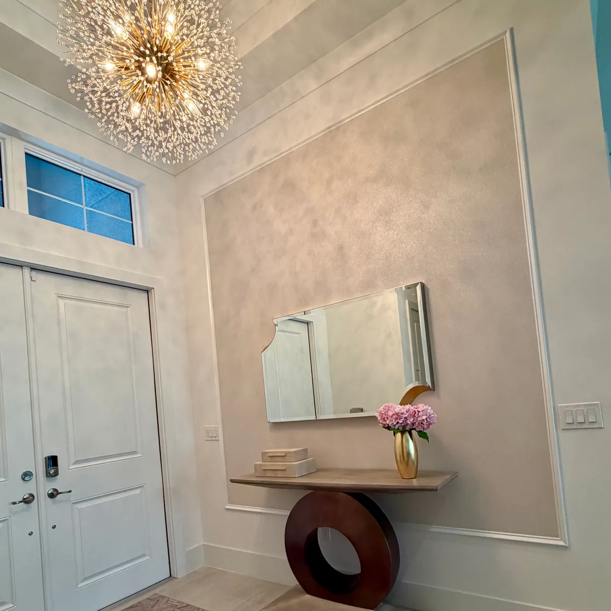Finished entryway remodel with chandelier and accent wall trim by Smart Solutions SRQ in Sarasota, FL